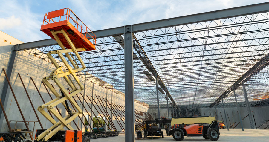 Close up of an industrial development with steel frames and construction vehicles