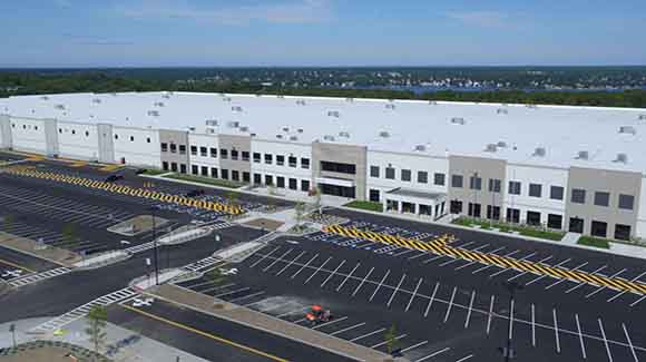Aerial view of large distribution center and parking lot