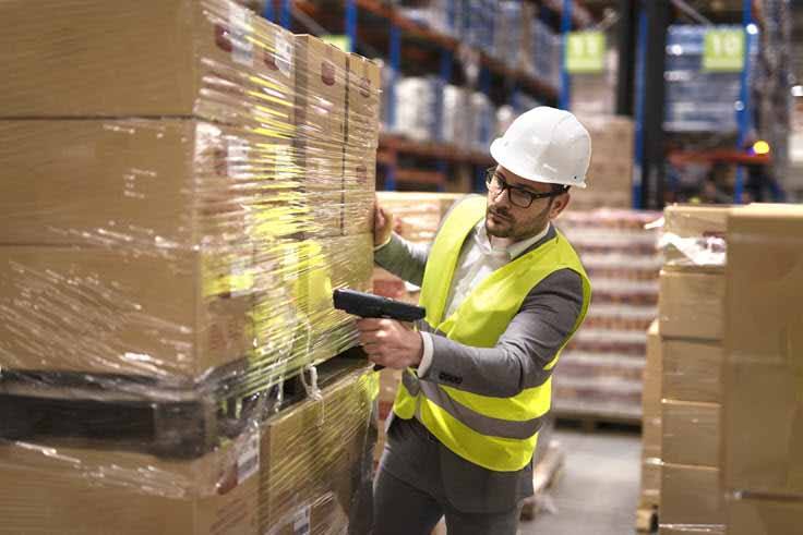 Warehouse worker scanning boxes on a pallet