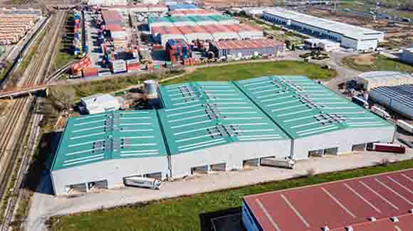Red rooftop of a large logistics warehouse