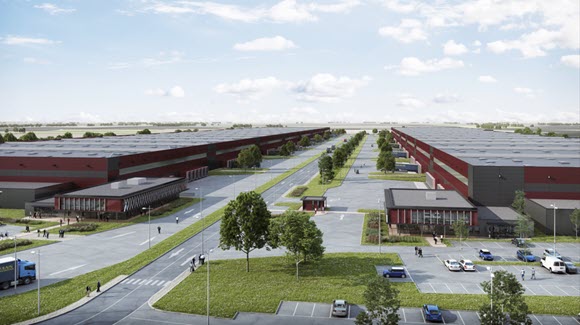 Two red and grey warehouses with road running in between