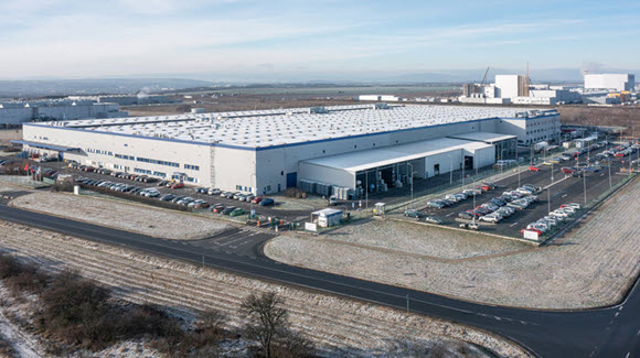 Aerial image of a large logistics facility with multiple parking lots in snowy conditions