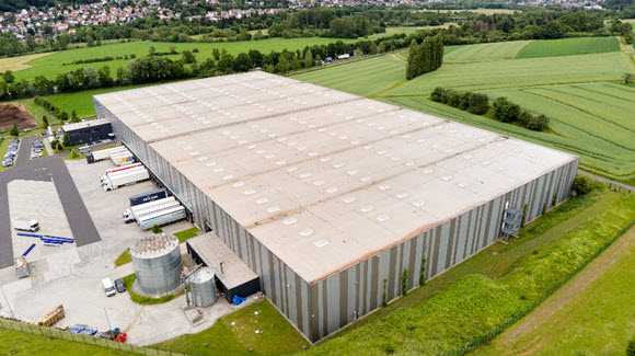 Aerial shot of large striped grey warehouse