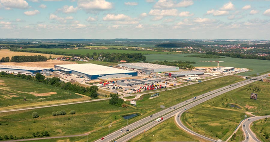 Aerial view of vast industrial complex by a highway network