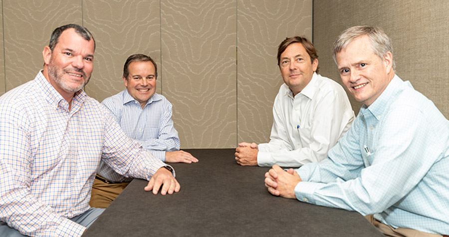 Four members of Clarion's industrial team (Andrew Lowe, John Killian, Dayton Conklin and David Confer) seated around a table