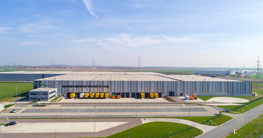 Photo of a large industrial property with an empty parking lot and loading dock