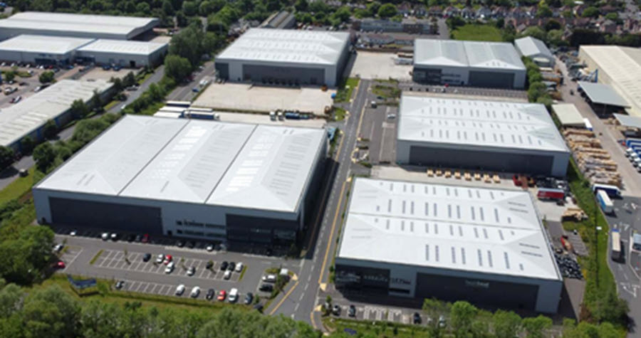 Aerial photo of large logistics park with parking lots and greenery