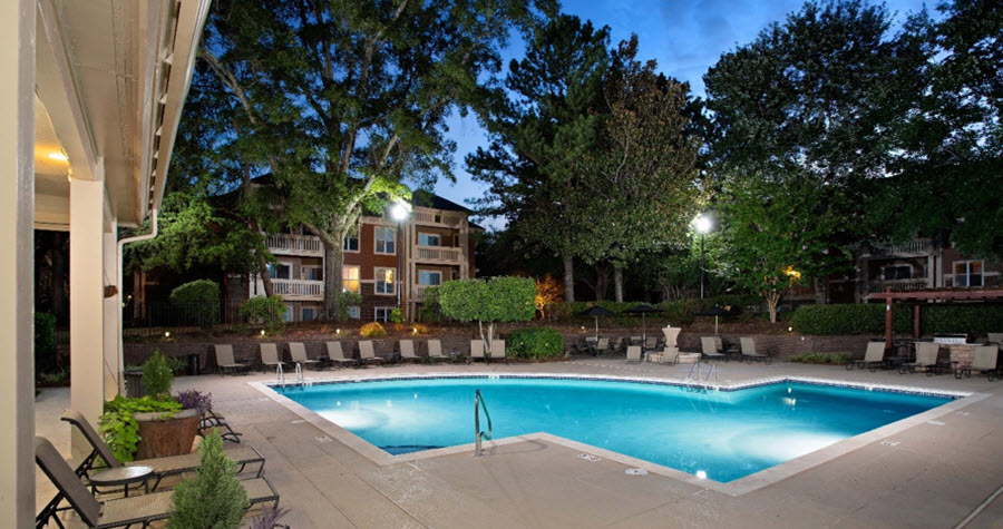 Multifamily property with a pool at nighttime