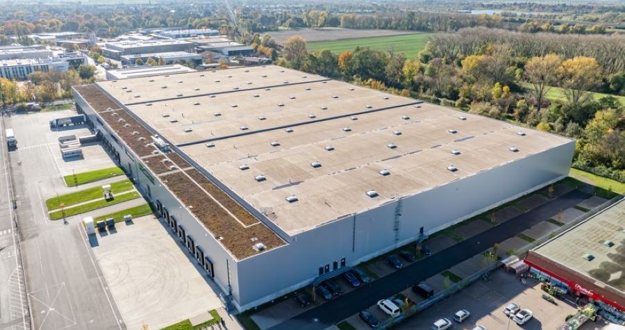 Aerial image of a large industrial complex next to fields of trees