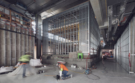 Construction workers surrounded by large interior beams