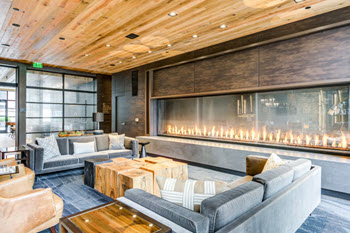 Upscale lobby with hardwood ceilings, 10-foot wide fireplace and modern furnishings