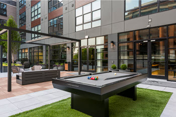 Outdoor recreation area with green lawn and billiards table