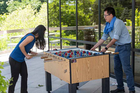 Employees playing foosball outdoors at Merritt 7 Corporate Park