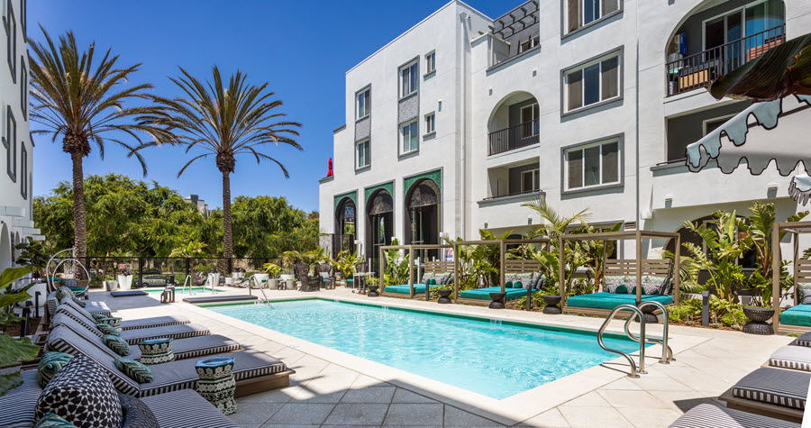 Remodeled outdoor pool deck with cabanas and lounge chairs