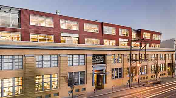 Four-story brick office building with road in front