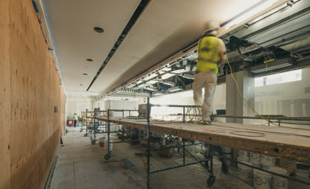 Construction worker on scaffolding - interior room